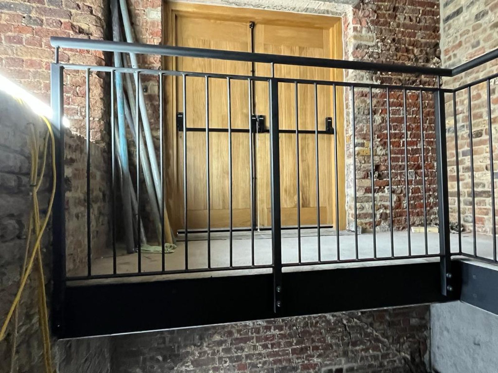 Bar railings by an oak barn door