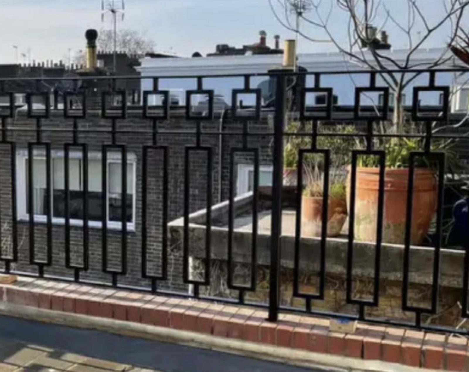 Decorative black railings on a roof terrace