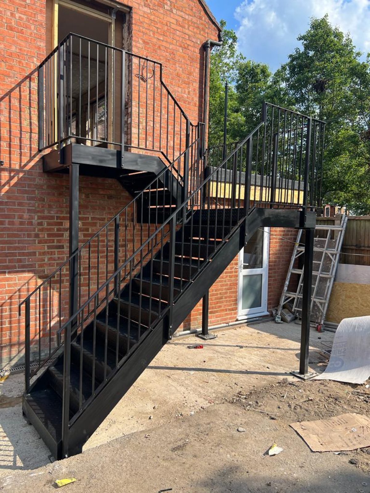 Black steel external staircase to a first-floor flat