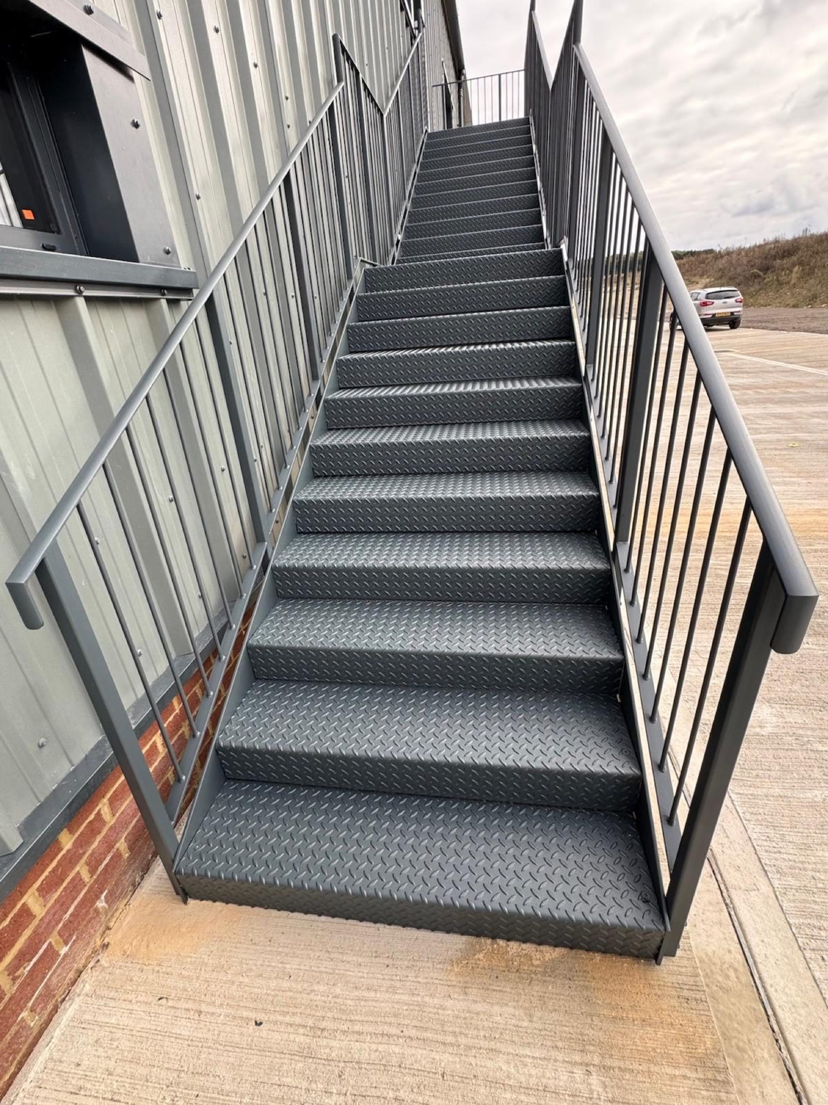 Galvanised staircase with chequer plate treads