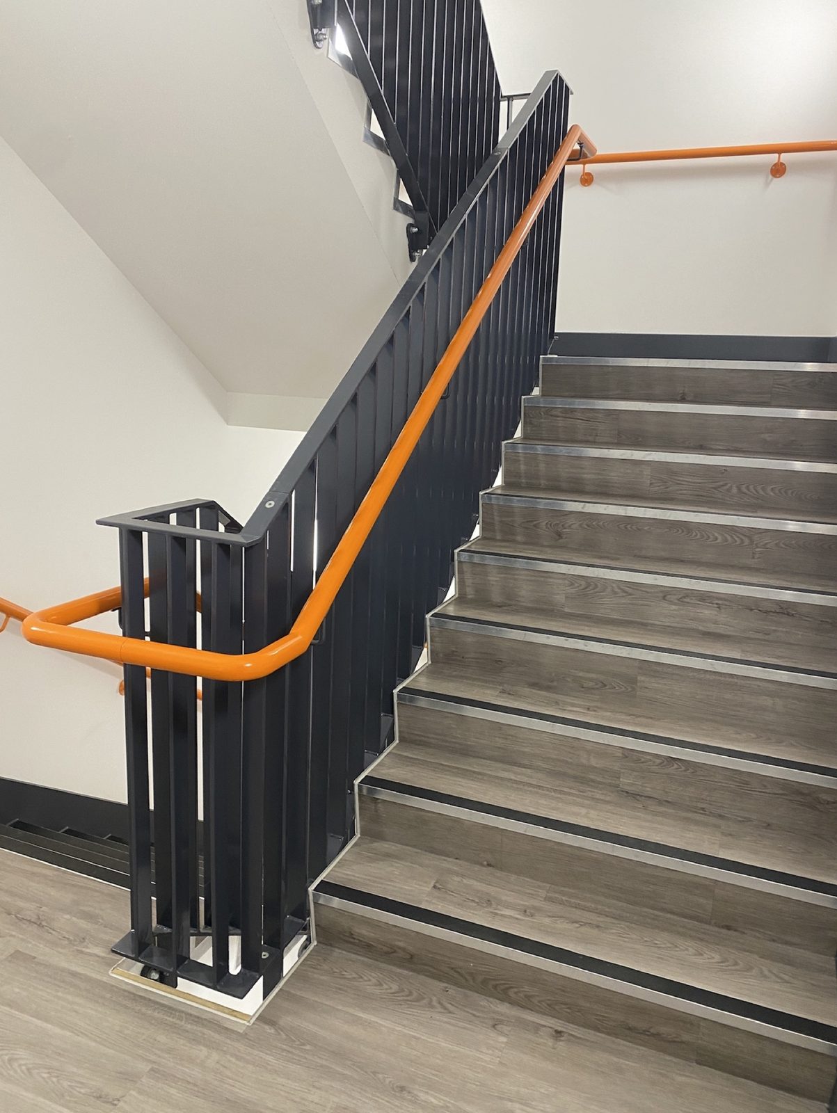 Internal fire stair with orange handrail