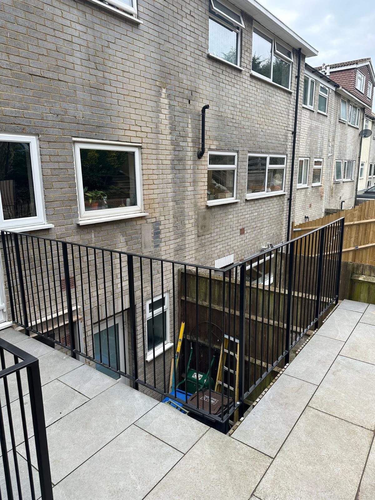 Black steel railings around a lightwell