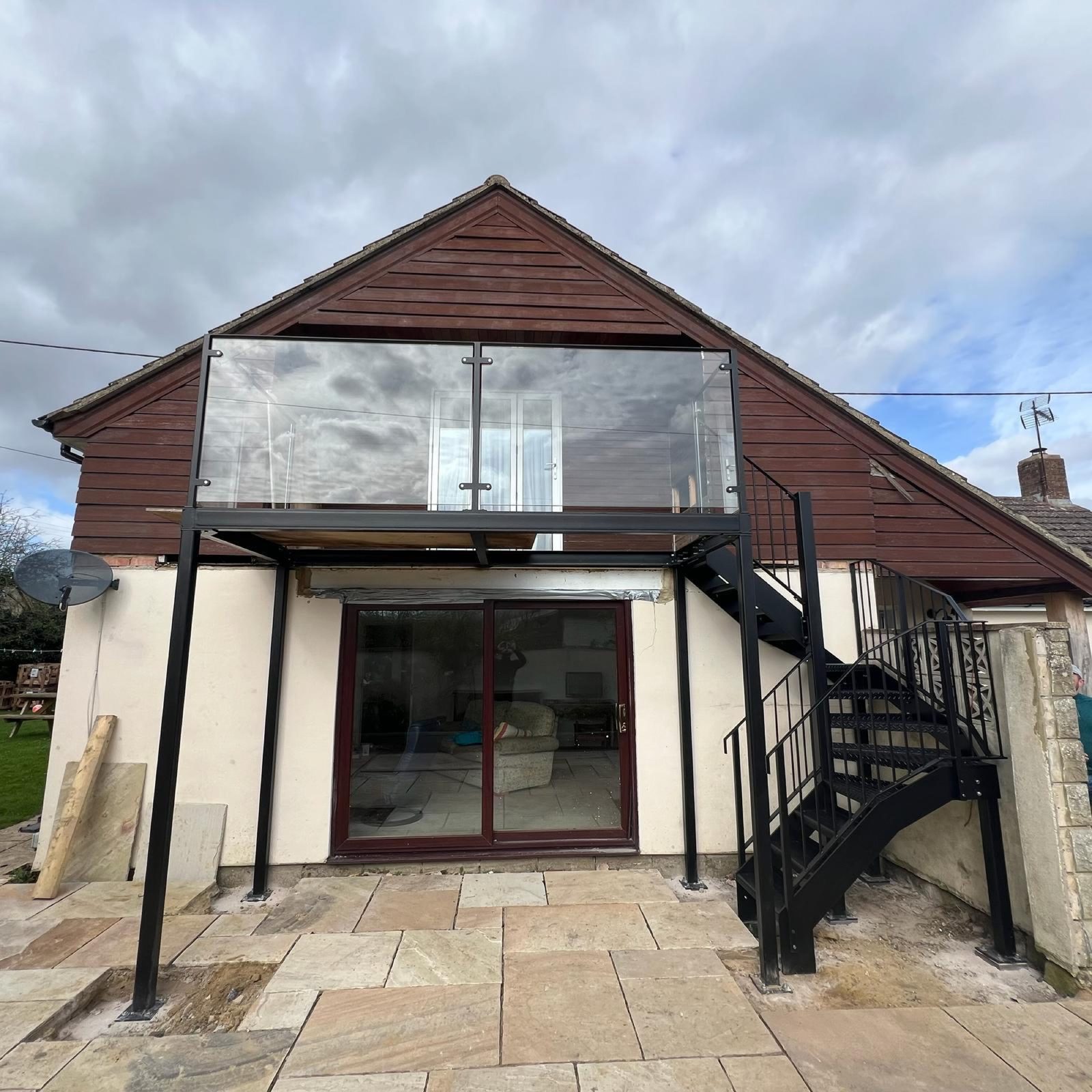 Spiral staircase and glass balcony on a barn conversion